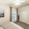 Large well lit bedroom with plush carpets and large windows 