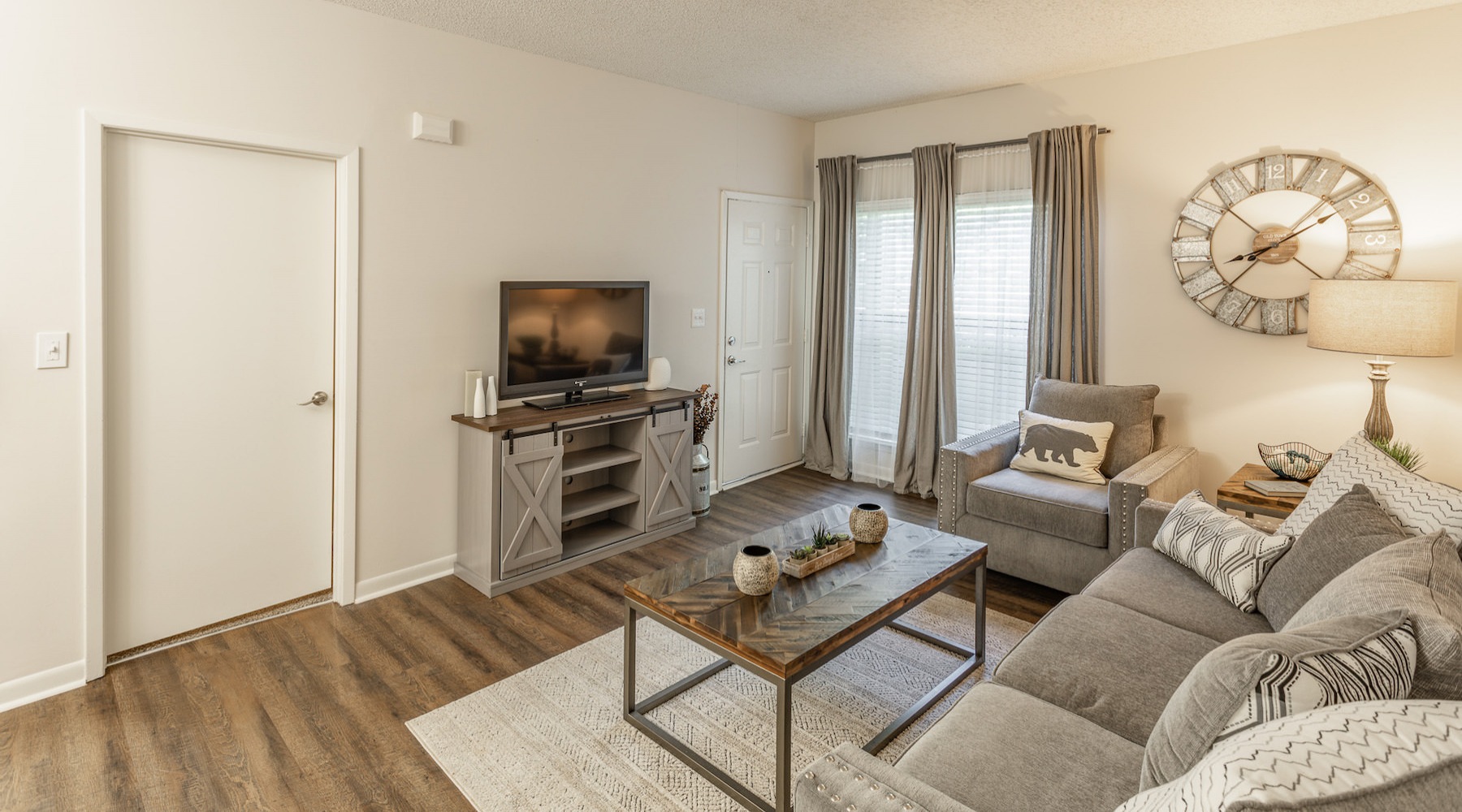 Spacious well lit living room with wood floors 