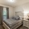 Large well lit bedroom with plush carpets and large windows 