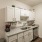 Spacious and well lit kitchen with wood flooring and stainless steel appliances