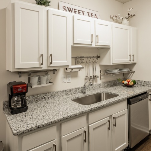 Kitchen Spacious and well lit kitchen with wood flooring and stainless steel appliances